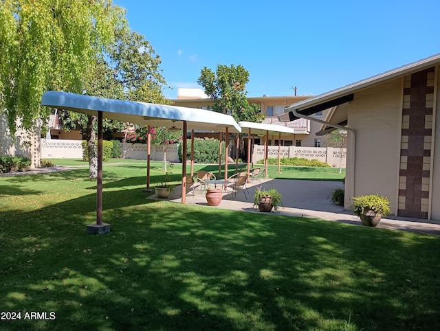 view of property's community with a patio area and a yard