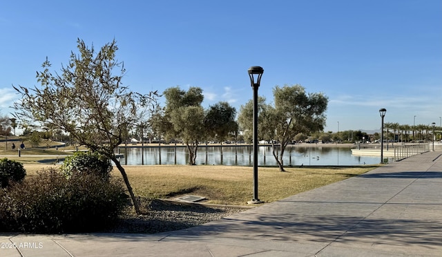 view of property's community featuring a yard and a water view