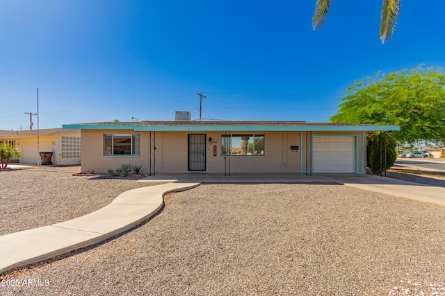 ranch-style home featuring driveway and a garage