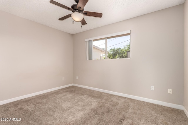 spare room featuring a textured ceiling, ceiling fan, baseboards, and carpet floors