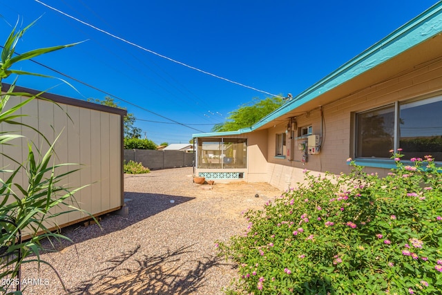 view of yard featuring a storage shed, an outdoor structure, and a fenced backyard