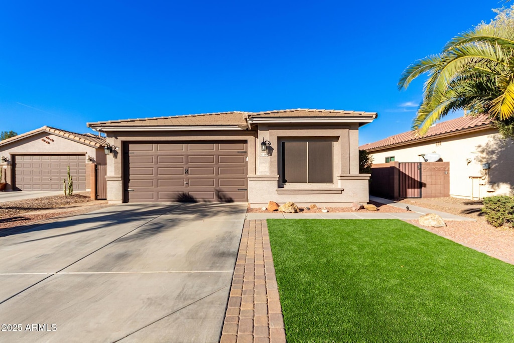 view of front of home featuring a front lawn and a garage