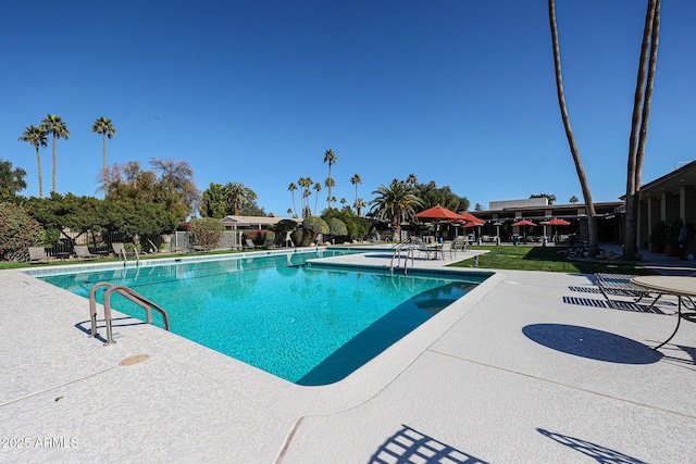 view of swimming pool with a patio