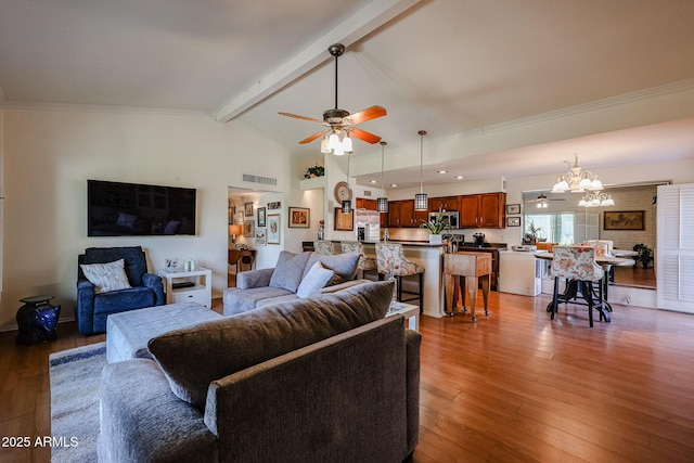 living room featuring hardwood / wood-style flooring, beam ceiling, ceiling fan with notable chandelier, and crown molding