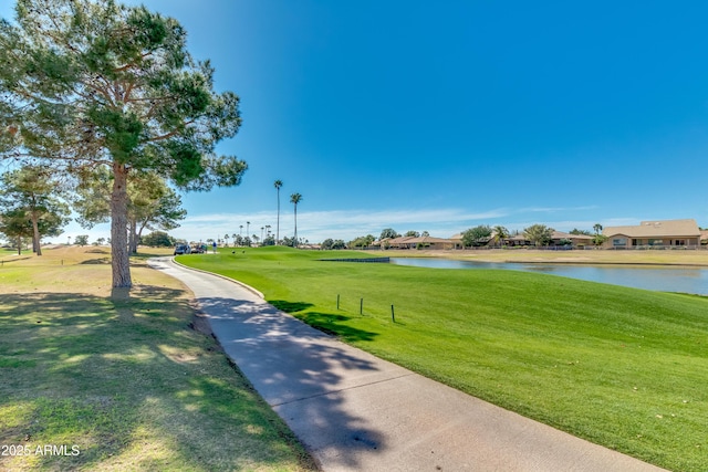 surrounding community with a lawn and a water view