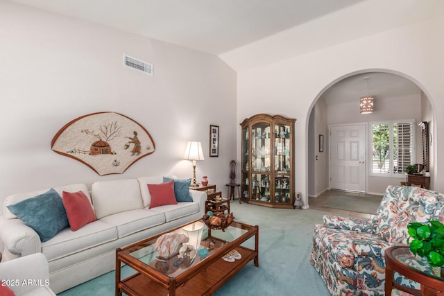 living room with lofted ceiling and light colored carpet