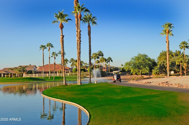 view of community with a water view and a yard