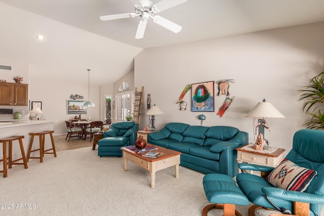 carpeted living room with vaulted ceiling and ceiling fan