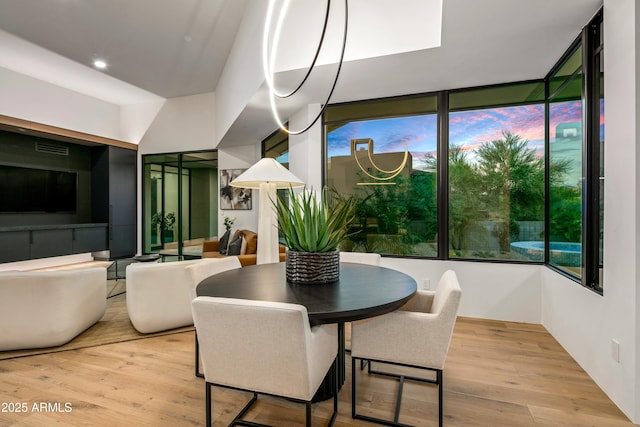 dining space featuring wood finished floors and visible vents