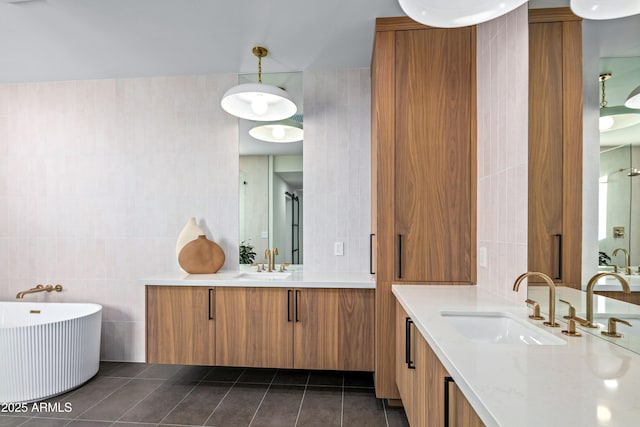 bathroom featuring a sink, tile walls, and tile patterned floors