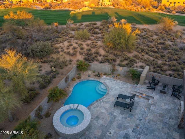 view of pool with a patio, a fenced backyard, and a pool with connected hot tub