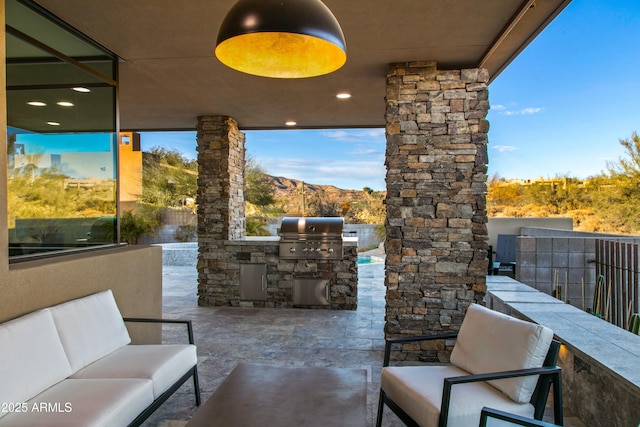 view of patio / terrace with an outdoor hangout area, area for grilling, and a mountain view