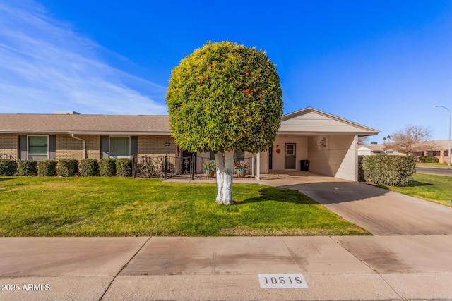 ranch-style house featuring a front lawn and a carport