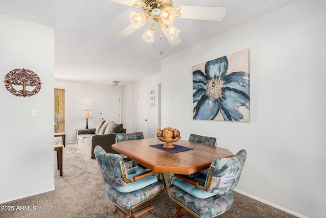 dining room with ceiling fan, carpet, and a textured ceiling