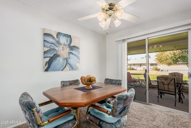 dining room with ceiling fan, carpet, and a textured ceiling