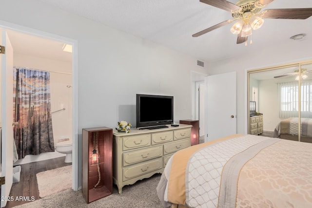 bedroom with ensuite bath, light hardwood / wood-style flooring, a closet, and ceiling fan