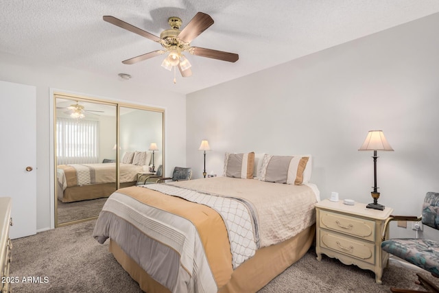 carpeted bedroom featuring ceiling fan, a closet, and a textured ceiling