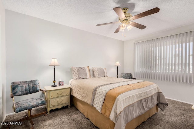 carpeted bedroom featuring ceiling fan and a textured ceiling