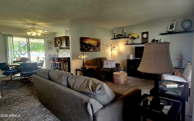 carpeted living room with ceiling fan and a textured ceiling