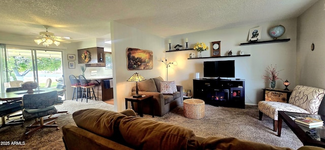 carpeted living room with ceiling fan and a textured ceiling