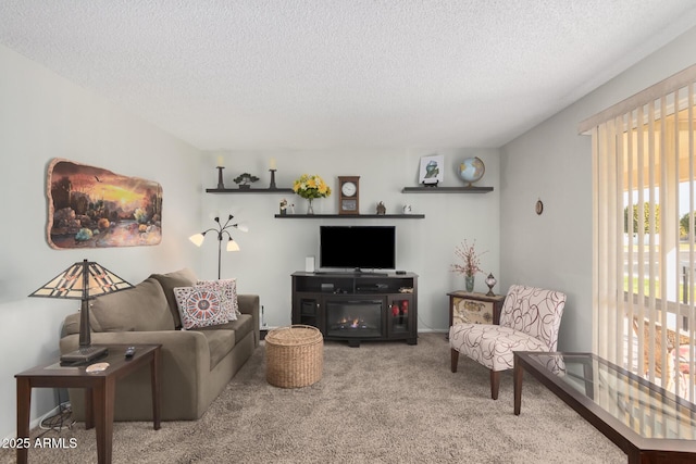 carpeted living room featuring a fireplace and a textured ceiling