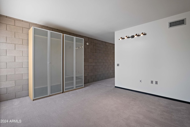 unfurnished room featuring light carpet