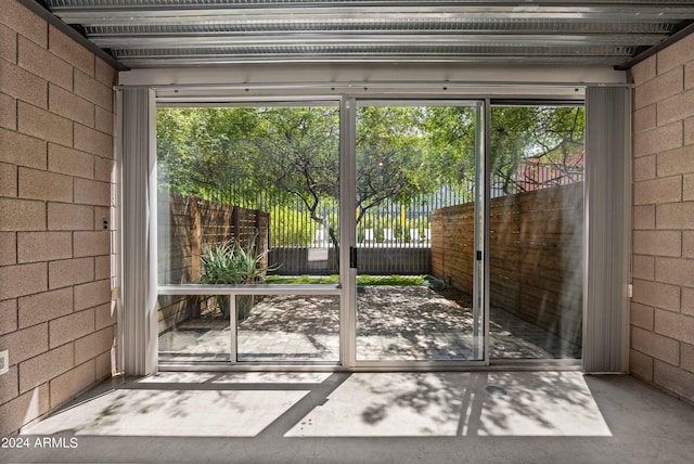 doorway featuring a healthy amount of sunlight and concrete floors