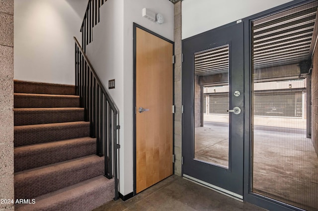 stairs featuring concrete floors