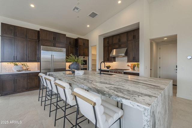 kitchen with under cabinet range hood, a sink, visible vents, and recessed lighting