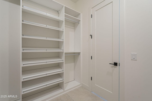 spacious closet featuring tile patterned flooring