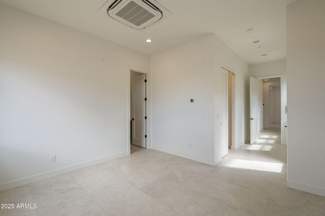 spare room featuring baseboards, visible vents, and recessed lighting
