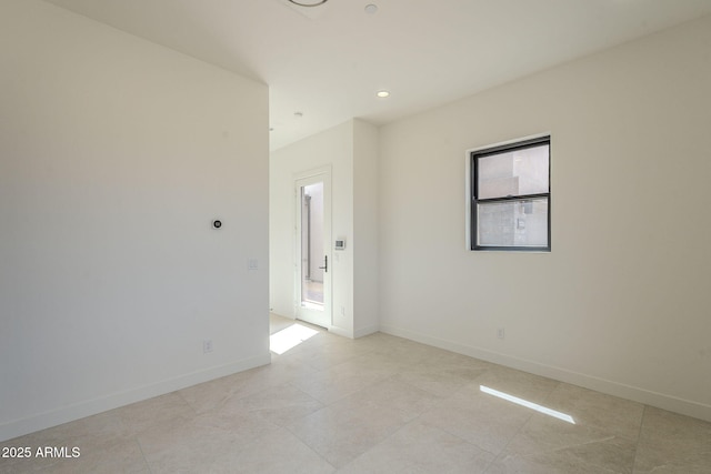 empty room with baseboards, recessed lighting, and light tile patterned flooring