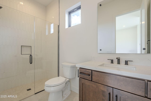 bathroom featuring a shower stall, toilet, vanity, and tile patterned flooring