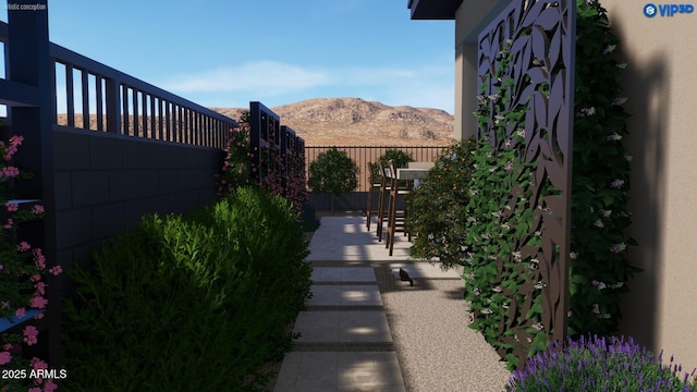 view of yard with fence and a mountain view