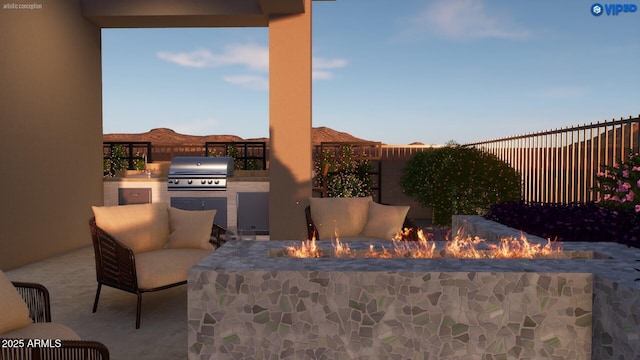view of patio / terrace featuring a grill, exterior kitchen, an outdoor fire pit, and fence private yard