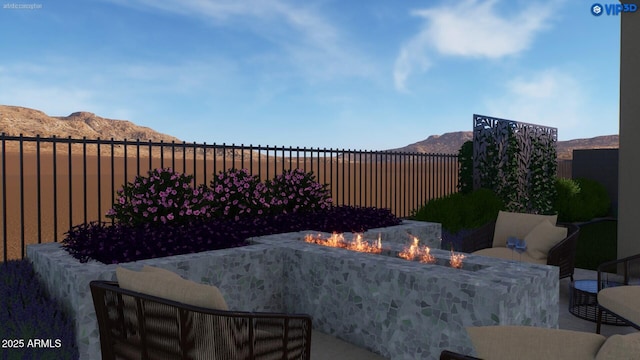 view of patio featuring a fire pit, a fenced backyard, and a mountain view
