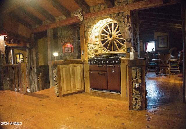 interior space featuring hardwood / wood-style floors and lofted ceiling with beams