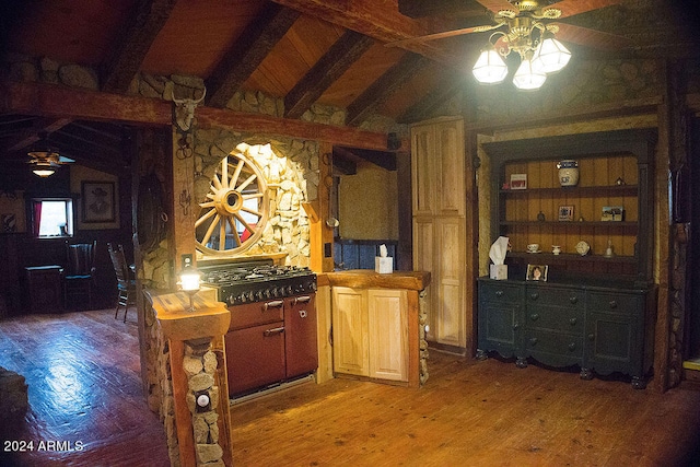 kitchen with ceiling fan, hardwood / wood-style flooring, wood counters, and vaulted ceiling with beams