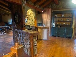 bar featuring lofted ceiling with beams and wood-type flooring