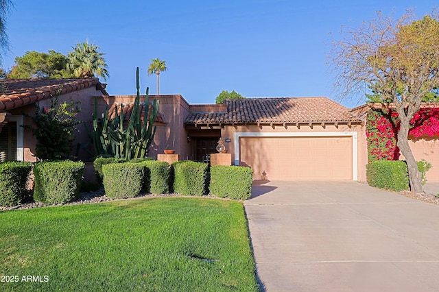 view of front of home with stucco siding, a tile roof, concrete driveway, a front yard, and a garage