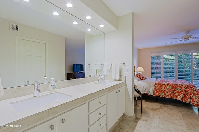 full bathroom with ensuite bathroom, a sink, visible vents, and a ceiling fan