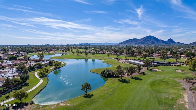 drone / aerial view with golf course view and a water and mountain view