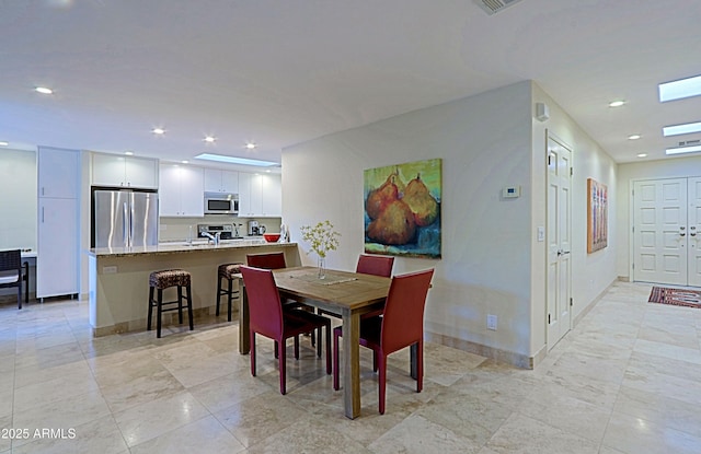 dining space featuring baseboards and recessed lighting