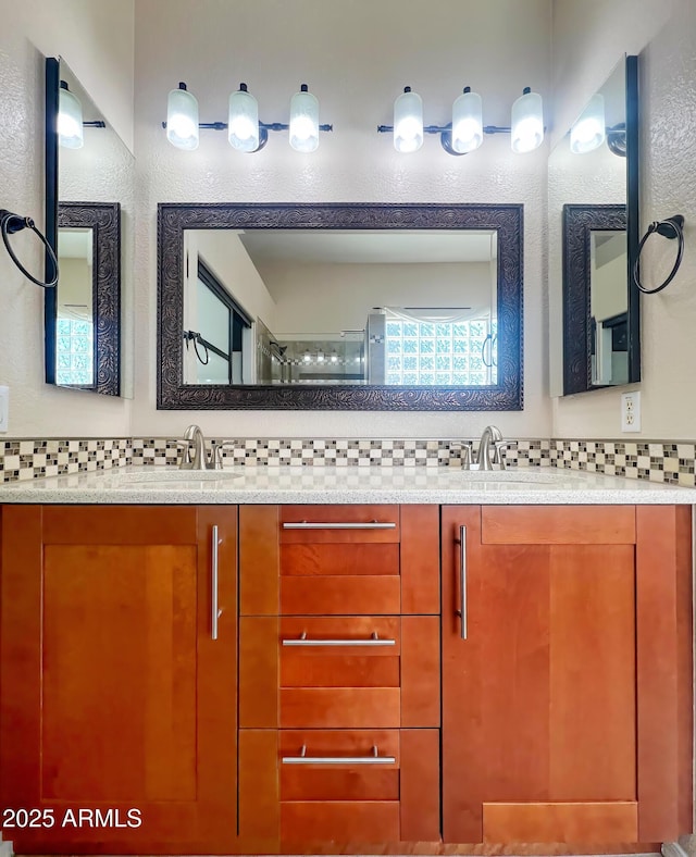 bathroom featuring decorative backsplash and vanity