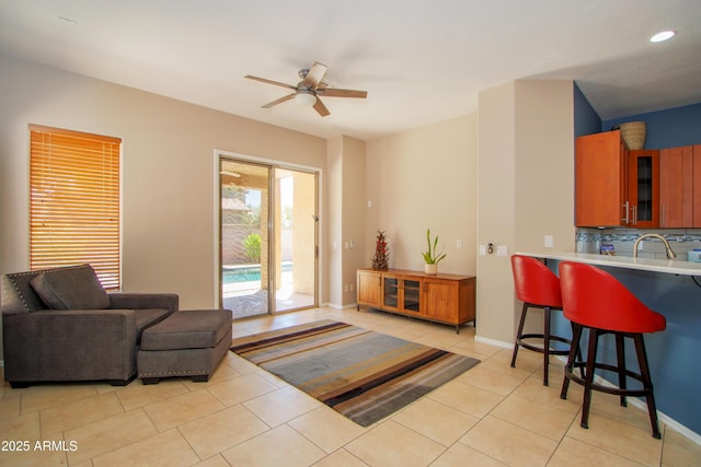 living room with a ceiling fan, light tile patterned floors, baseboards, and recessed lighting