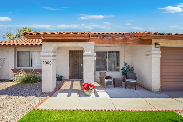 2009 W Calle Del Norte Dr, Chandler, AZ 85224 - doorway to property with stucco siding, a patio area, a pergola, and a tile roof