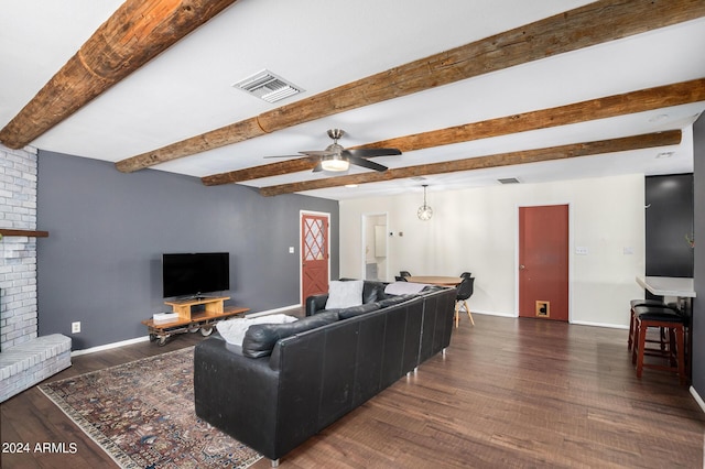 living room with dark wood-style flooring, a fireplace, visible vents, and baseboards