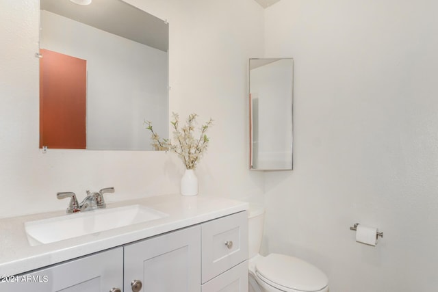 bathroom featuring toilet and vanity