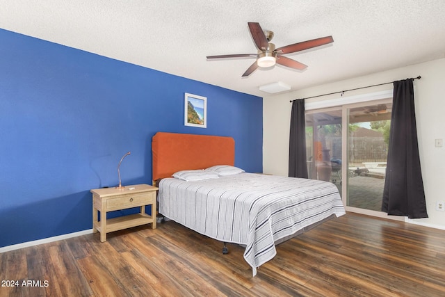 bedroom featuring a textured ceiling, dark wood-type flooring, baseboards, and access to exterior