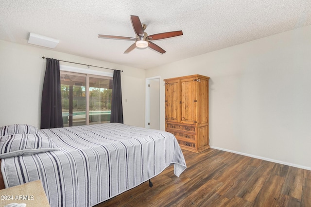 bedroom featuring a textured ceiling, dark wood finished floors, a ceiling fan, and baseboards